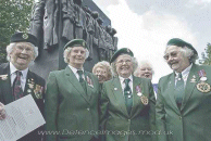 Veterans in uniform at the memorial